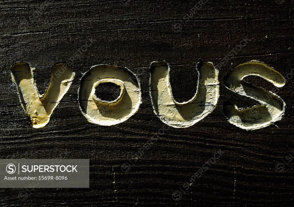 ´You´ typography in French engraved in wood