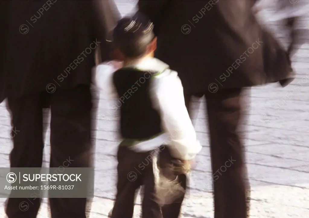 Israel, Jerusalem, close up of little Jewish boy walking, rear view, blurry