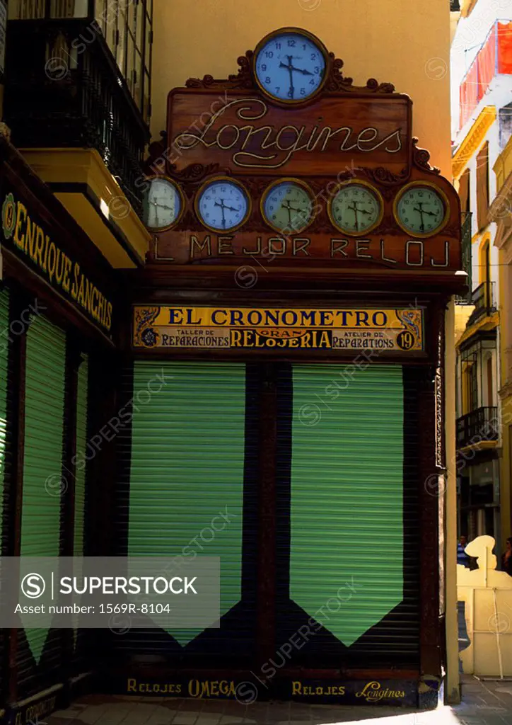 Collection of signs and clocks on street corner
