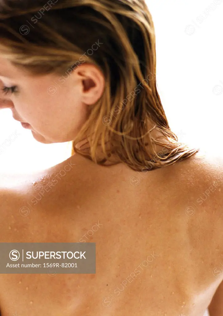 Woman with bare back, head turned to side, rear view, close-up