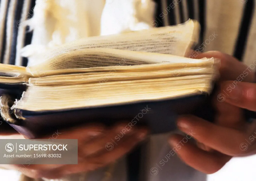 Jewish man´s hands holding Torah, close-up