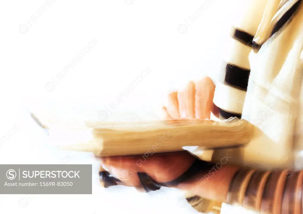 Hands of Jewish man holding Torah