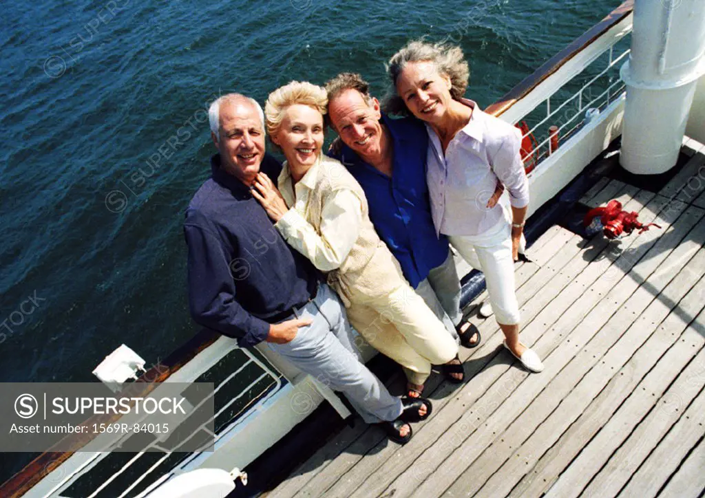 Mature couples standing next to railing of boat, portrait, high angle view