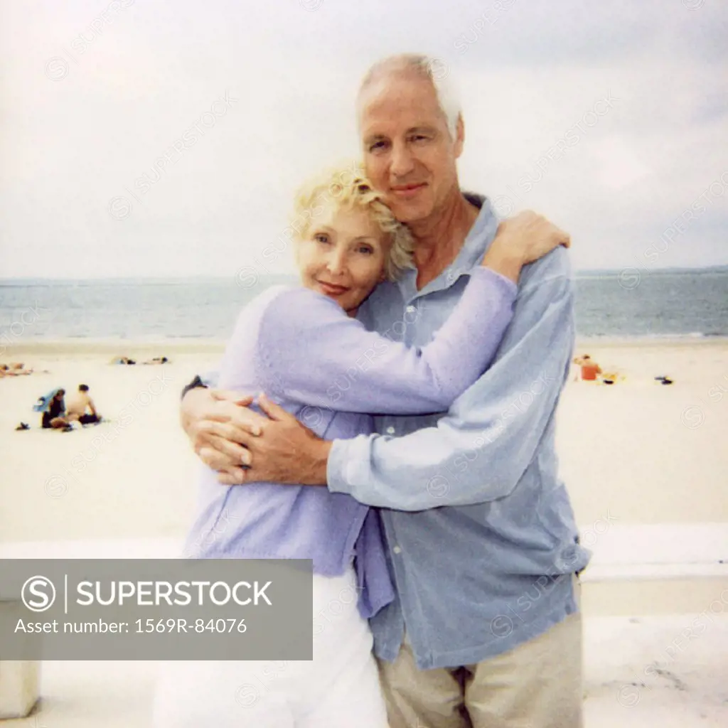Mature couple embracing at the beach, portrait, soft focus