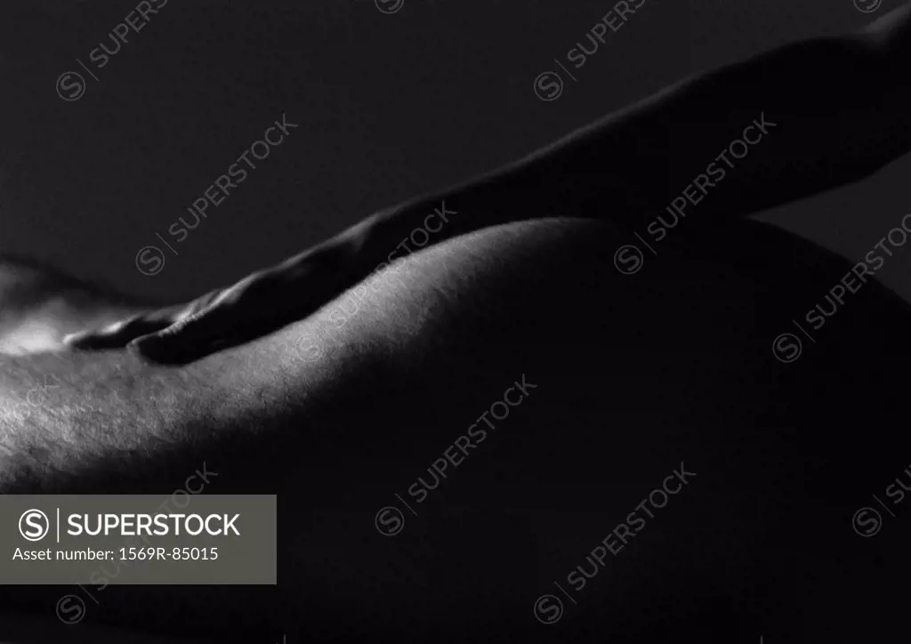 Hand on buttocks, close-up, black and white