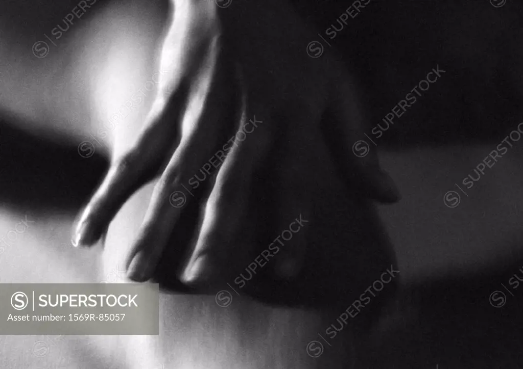 Woman´s hand on arm, close-up, blurred black and white