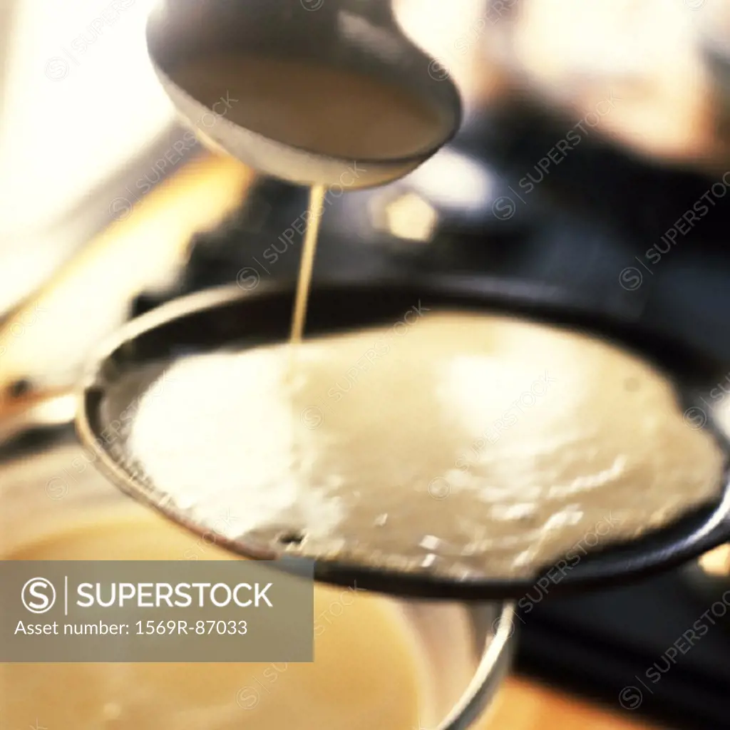 Close-up of batter being poured onto a skillet