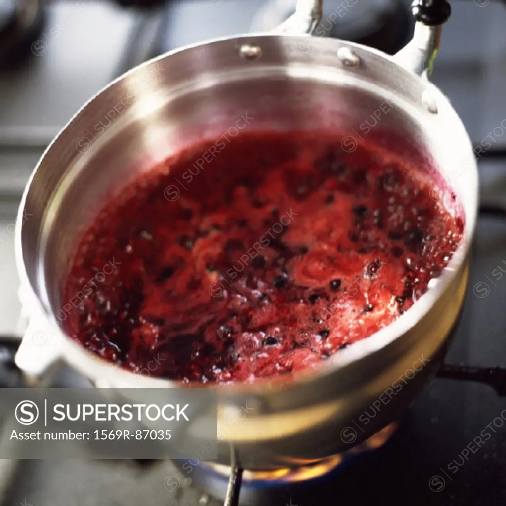 Close-up of berries being cooking in a pot on the stove
