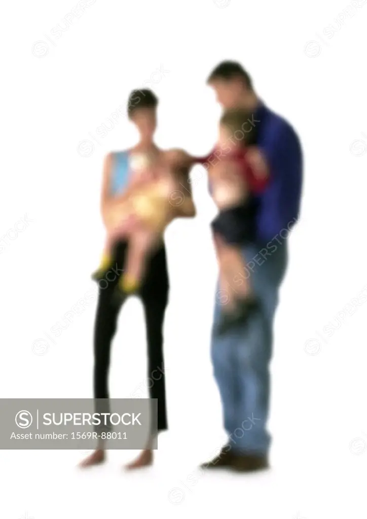 Silhouette of parents holding children, on white background, defocused