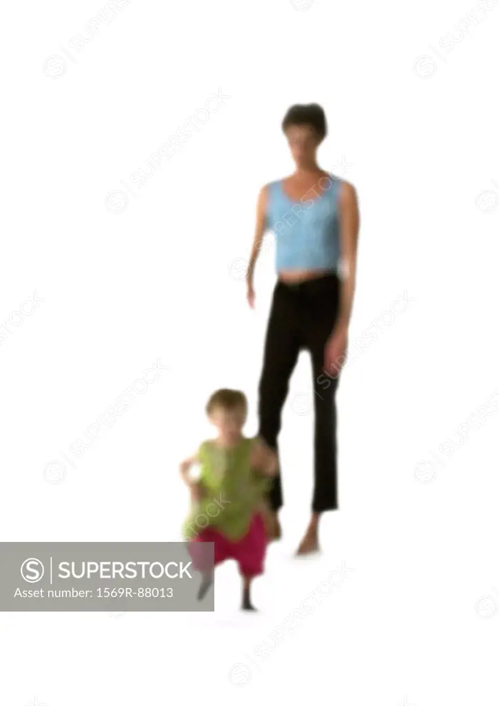 Silhouette of woman and child, on white background, defocused