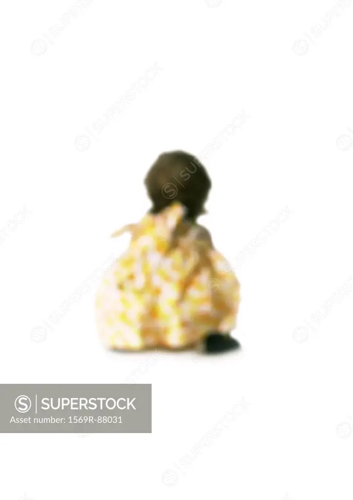 Silhouette of child sitting down, rear view, on white background, defocused