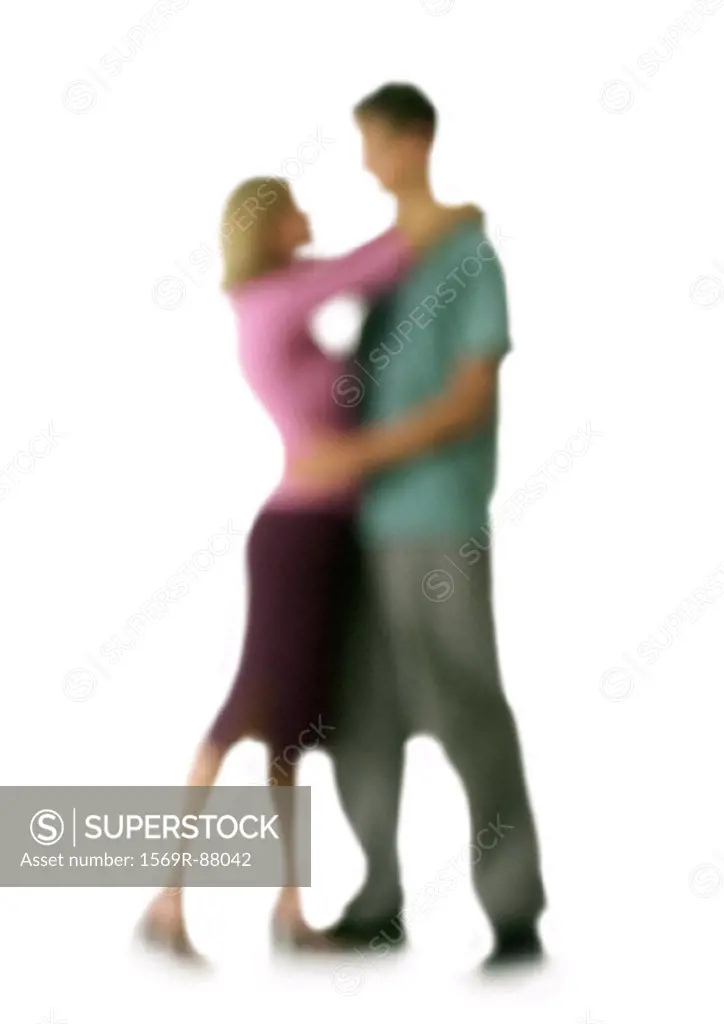 Silhouette of couple hugging, on white background, defocused