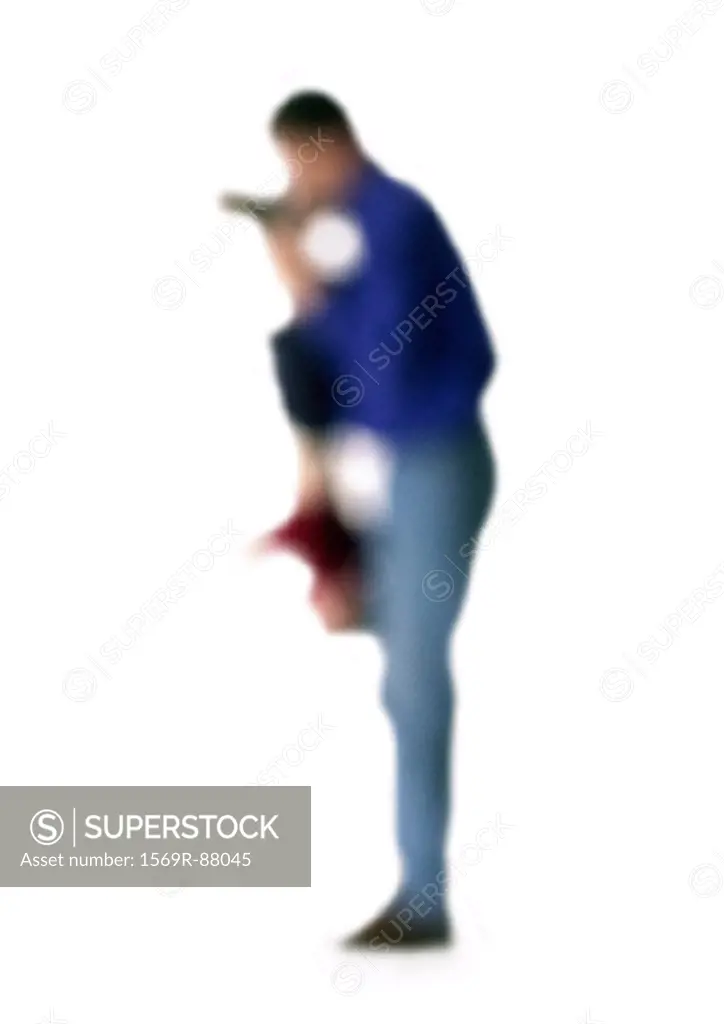 Silhouette of father holding child upside down, side view, on white background, defocused