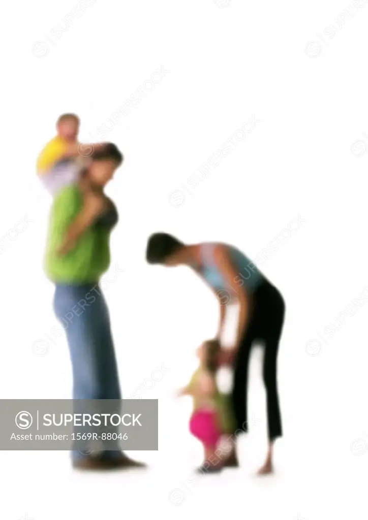 Silhouette of parents with two children, on white background, defocused