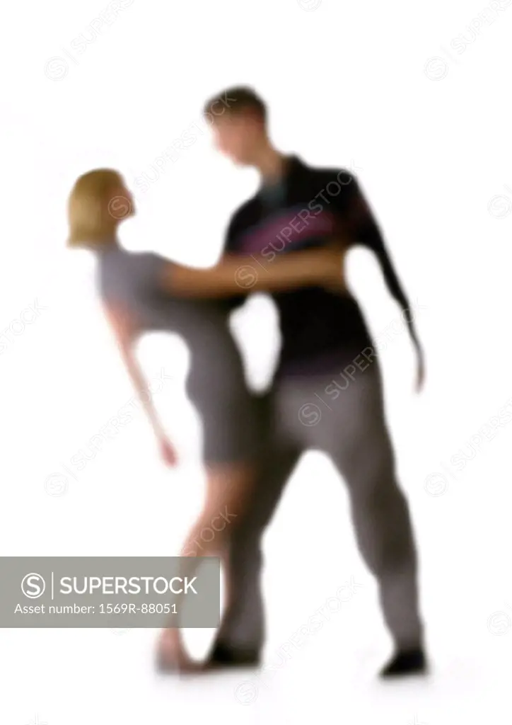 Silhouette of couple dancing, on white background, defocused
