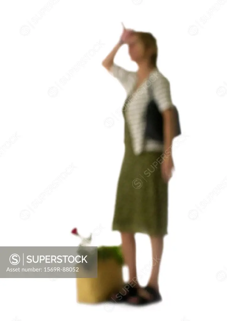 Silhouette of woman with shopping bag wiping forehead, on white background, defocused