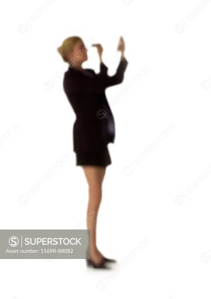 Silhouette of woman putting on make-up, on white background, defocused