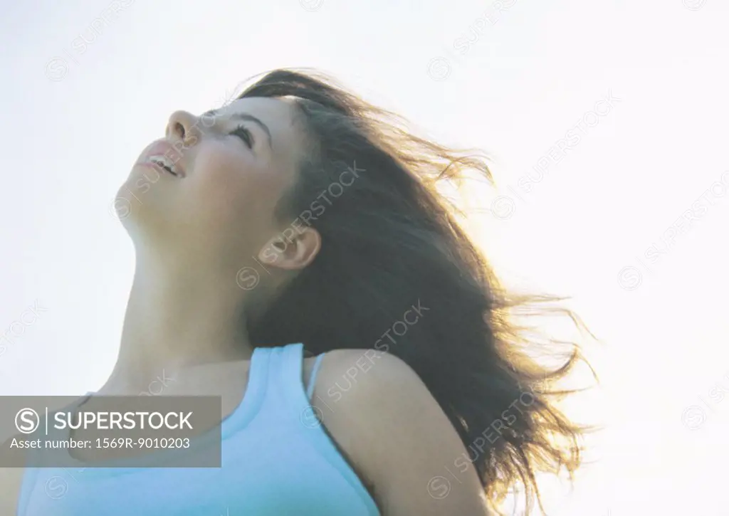 Girl with head back and wind in hair