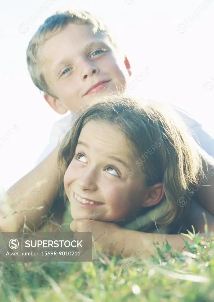 Boy and girl lying in grass