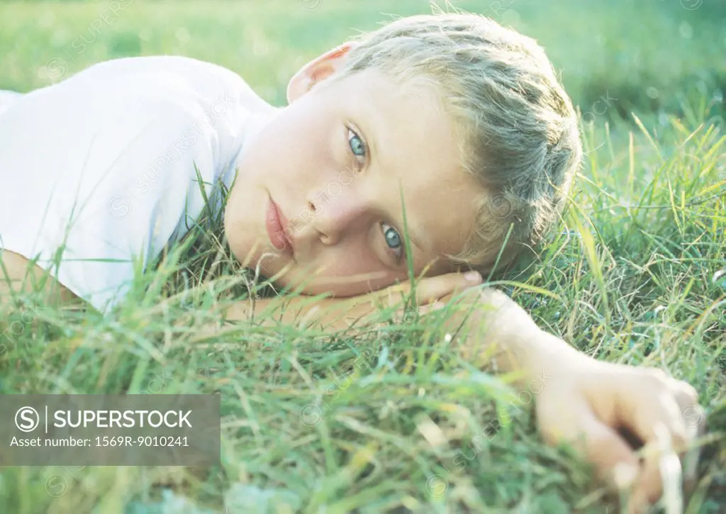 Boy lying in grass
