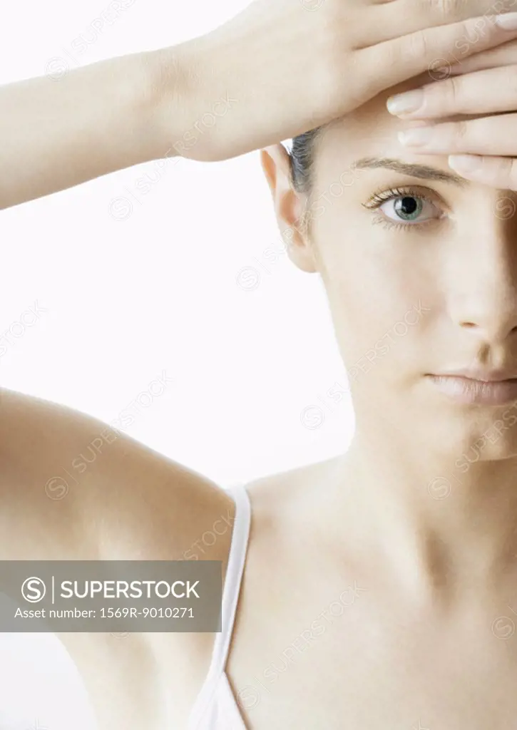 Woman with hands on forehead