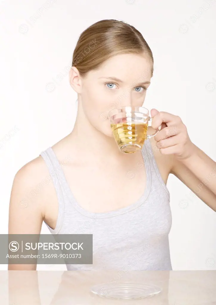 Young woman drinking herbal tea