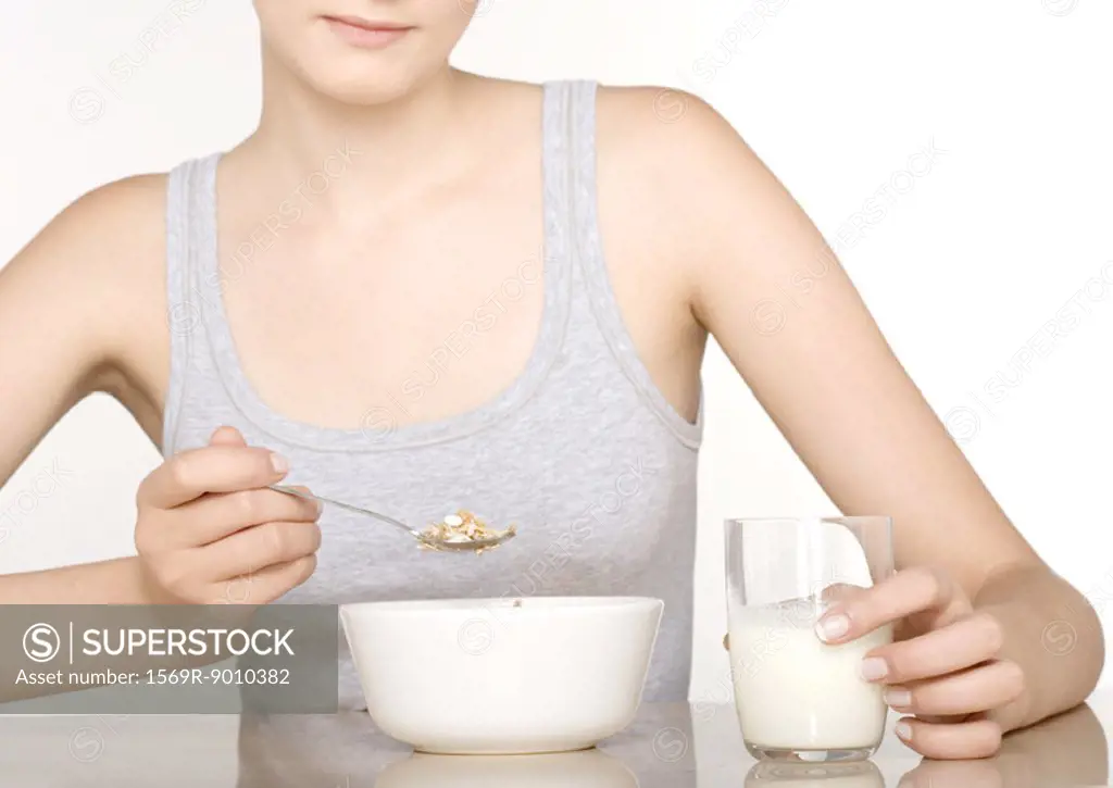 Young woman eating cereal
