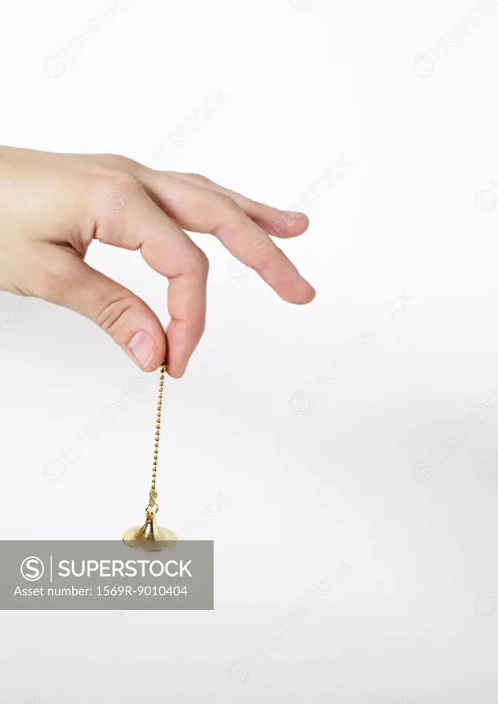 Hand holding pendulum