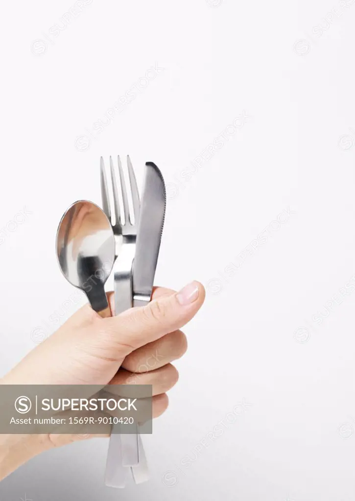 Hand holding silverware