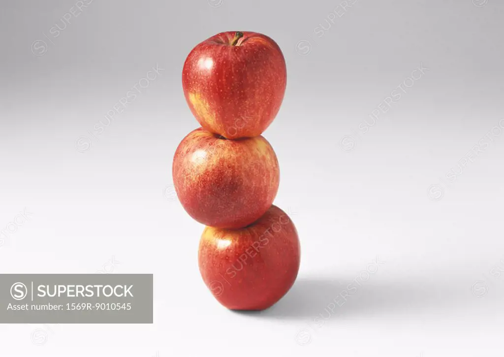 Three red apples, stacked one on the other