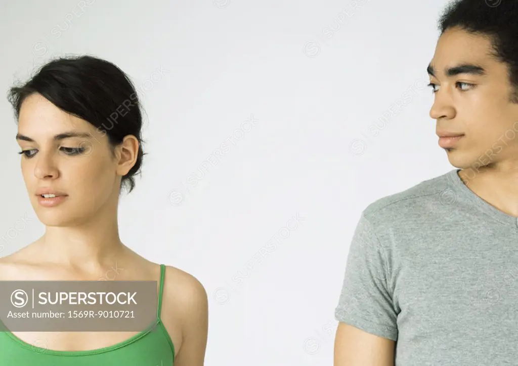 Young couple, woman looking away, man looking at woman