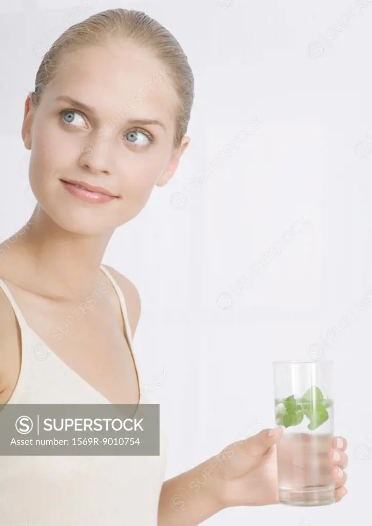 Woman holding glass with herbed water