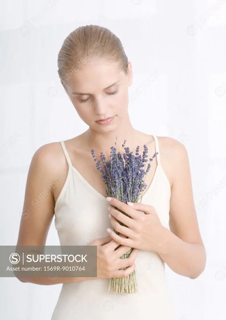 Young woman holding bouquet of lavendar