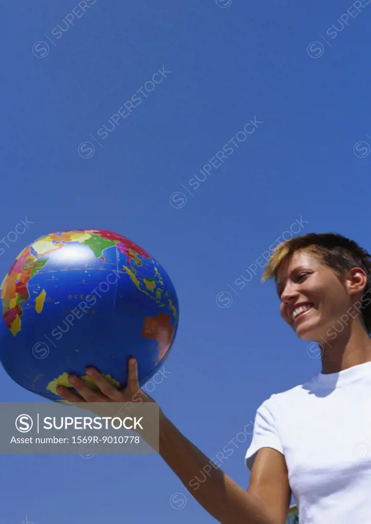 Young woman holding globe ball