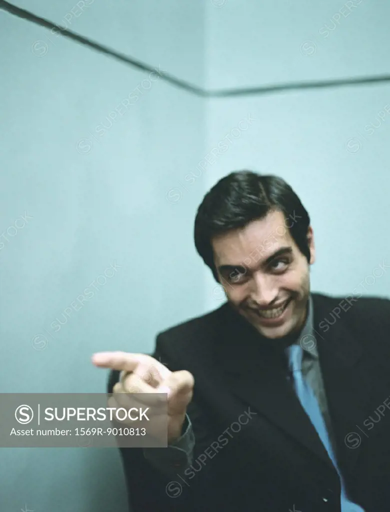 Businessman smiling and pointing