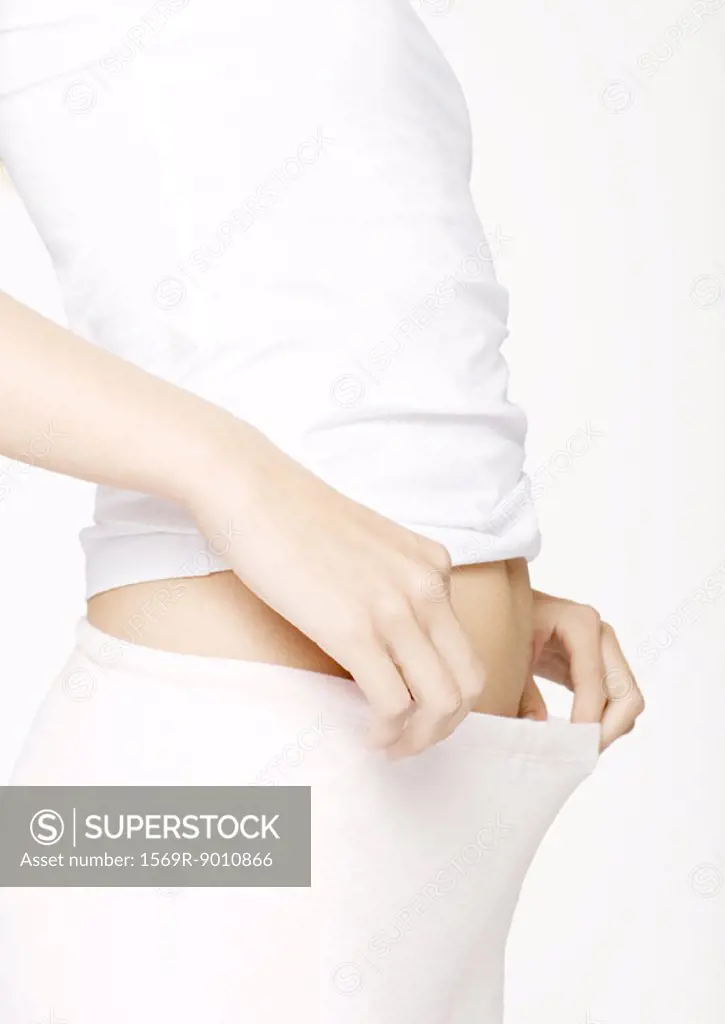 Woman pulling out pants waist