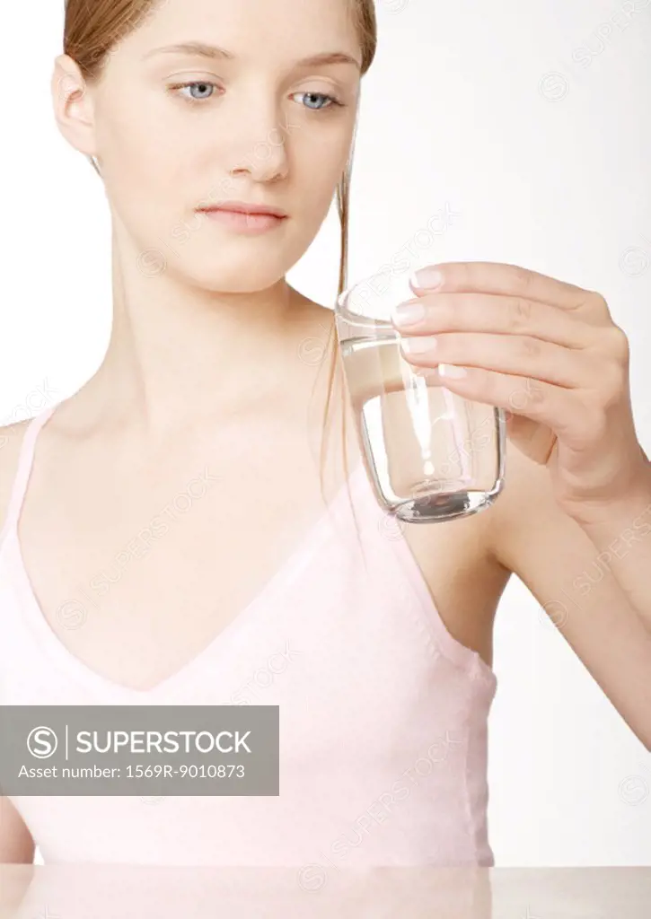 Woman looking at glass of water