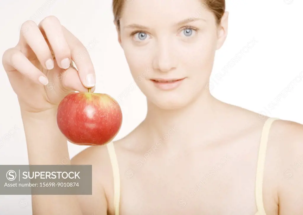 Woman holding up apple