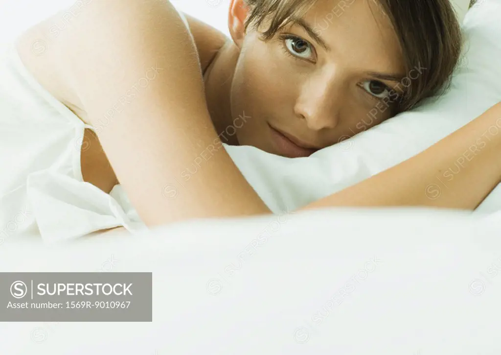 Young woman lying in bed, close-up