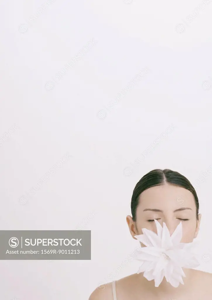 Woman with flower in mouth and eyes closed