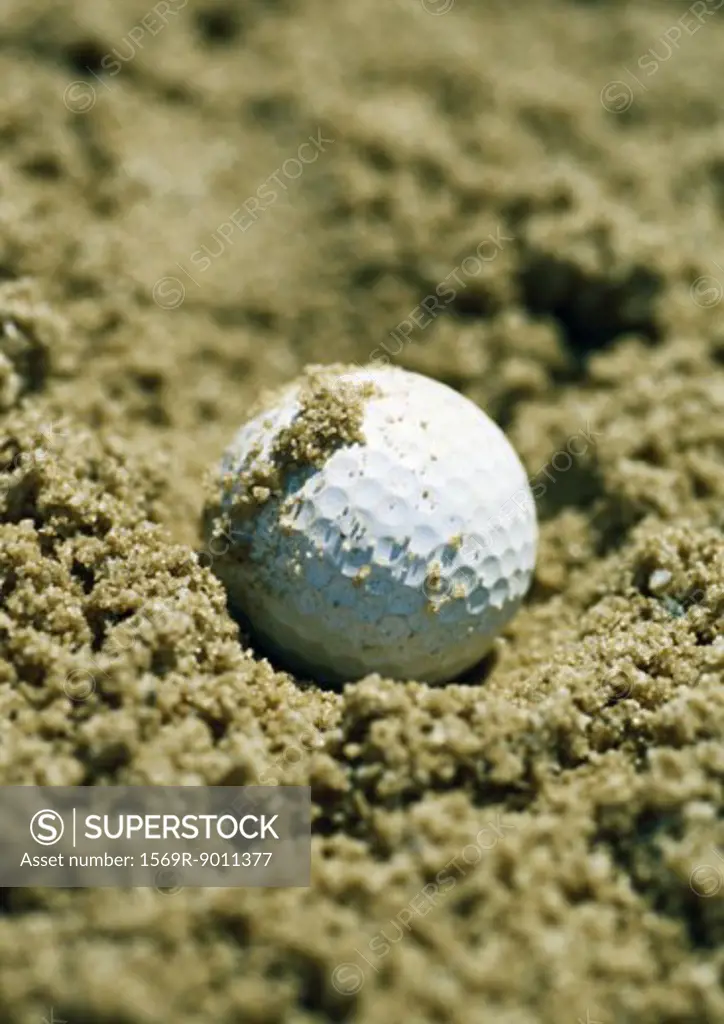 Golf ball in sand trap, close-up