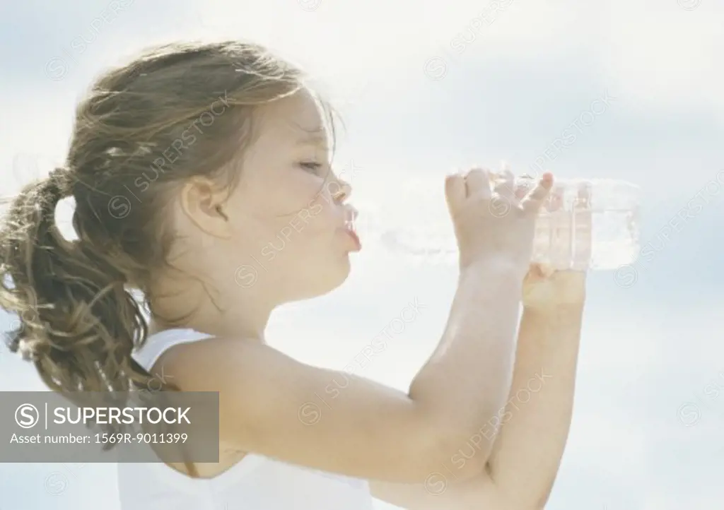 Little girl drinking water from bottle