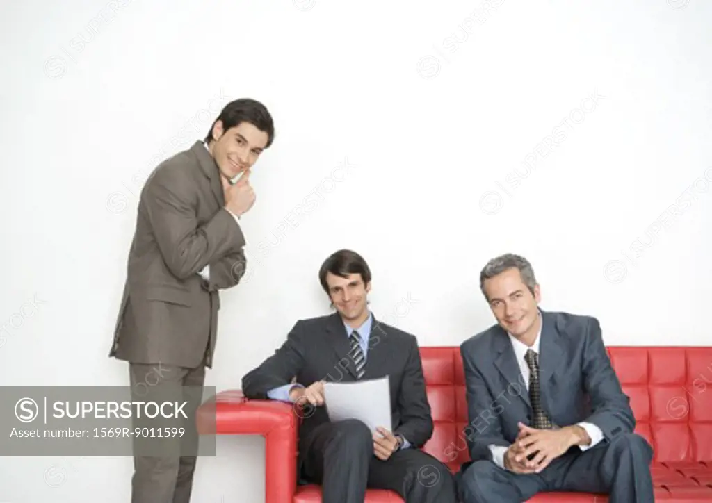 Three businessmen in office lobby