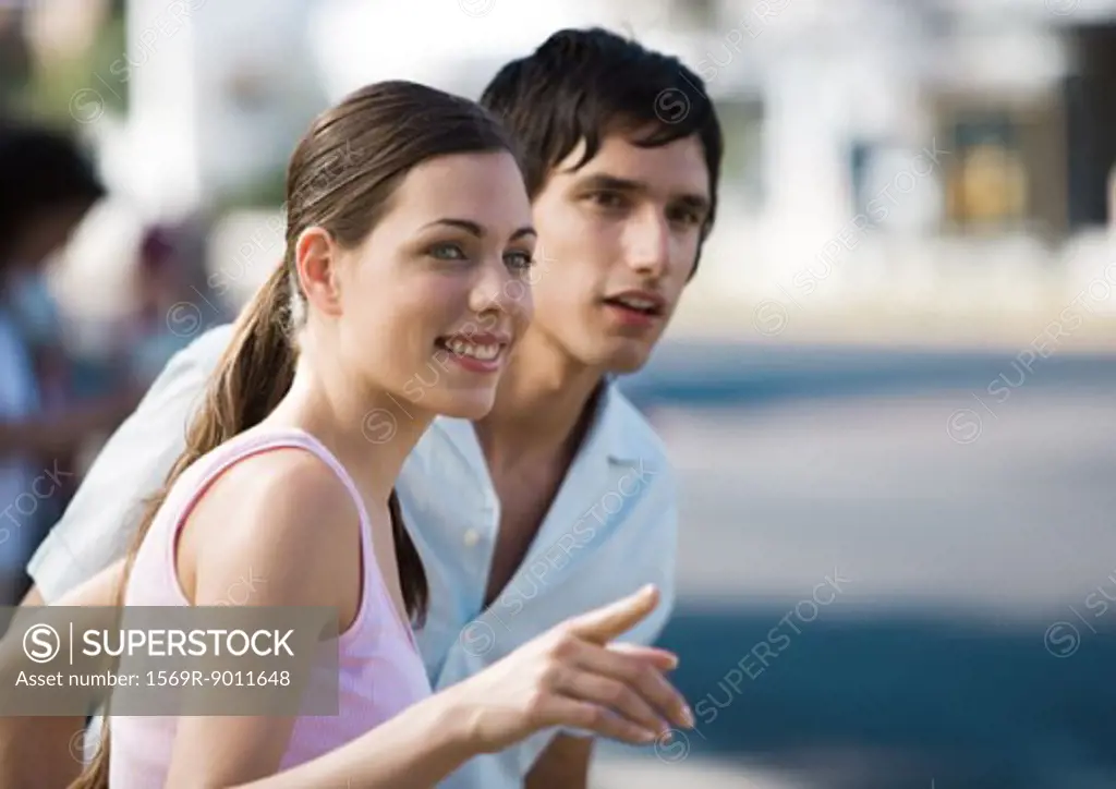 Young couple, woman pointing