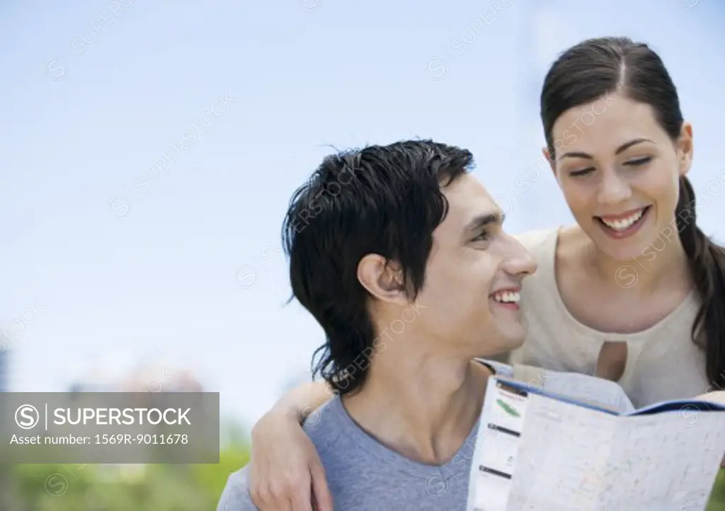Young couple looking at map together