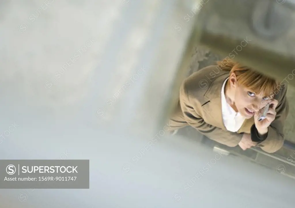 Woman using cell phone, high angle view