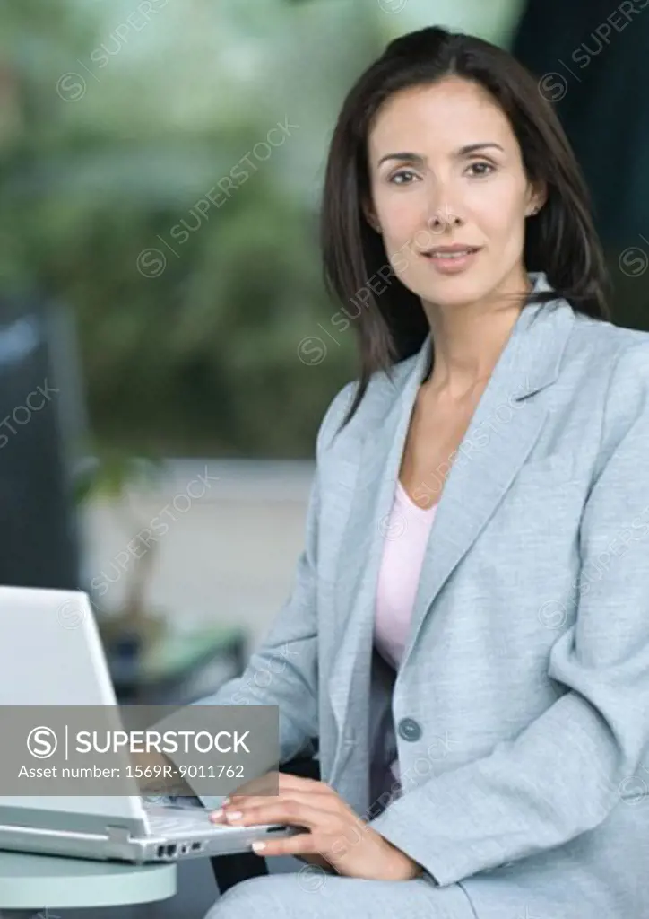 Businesswoman sitting with laptop