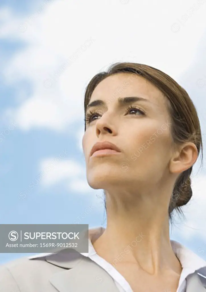 Woman looking into distance, portrait, low angle view