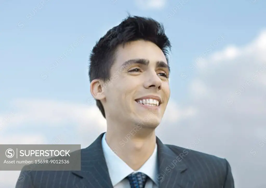 Young businessman smiling, portrait