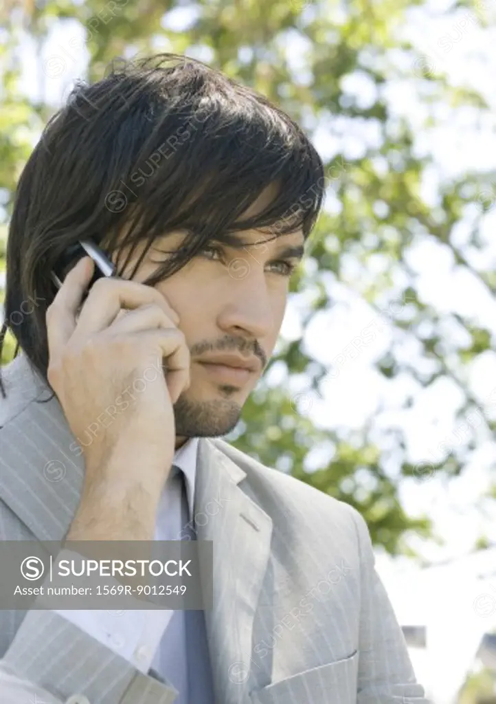 Young businessman using cell phone